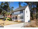 Side view of the house with a well manicured lawn, driveway, and front porch at 870 Gaston Sw St, Atlanta, GA 30310