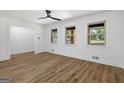 Bright living room featuring wood-look floors, white walls, and large windows that let in natural light at 1400 North Avenue Nw, Atlanta, GA 30318