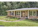 Welcoming brick ranch home with black shutters and covered entry at 3180 S Elizabeth Dr, Douglasville, GA 30135