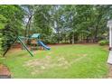 Spacious backyard with lush green lawn and a playset, perfect for outdoor activities at 3506 Billingsley Dr, Marietta, GA 30062