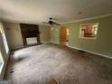 Inviting living room featuring a cozy brick fireplace and a ceiling fan for added comfort at 718 Hardy Way, Hiram, GA 30141