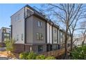 Modern townhome with mixed material exterior, including gray siding and brick with a rooftop deck at 1836 Memorial Dr # 303, Atlanta, GA 30317