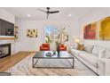 Open living room area featuring hardwood floors, modern lighting, and a marble fireplace at 1836 Memorial Dr # 303, Atlanta, GA 30317