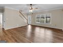 Bright living room featuring wood floors and a staircase and multiple windows to bring in the sunlight at 79 The Farm Rd, Mcdonough, GA 30252