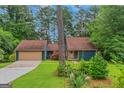 Charming home with a two-car garage, complemented by a well-manicured lawn and mature trees at 959 Sweet Briar Se Trl, Conyers, GA 30094