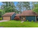 Charming home with a two-car garage, complemented by a well-manicured lawn and vibrant shrubbery at 959 Sweet Briar Se Trl, Conyers, GA 30094