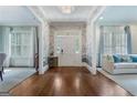 Elegant foyer with hardwood floors, decorative wallpaper, wainscoting and natural light at 785 Wilson Nw Rd, Atlanta, GA 30318