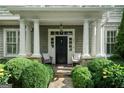 Inviting front porch with stone walkway, stately columns and covered entry with seating at 785 Wilson Nw Rd, Atlanta, GA 30318