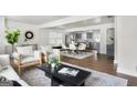 Open-concept living area with a modern design aesthetic, hardwood floors, and seamlessly flowing spaces at 1258 Campbellton Sw Rd, Atlanta, GA 30310
