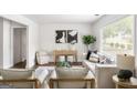 Bright living room with neutral décor, hardwood floors, and a stylish console table beneath a large window at 1258 Campbellton Sw Rd, Atlanta, GA 30310
