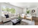 Inviting living space with hardwood floors and a decorative rug, complemented by neutral furnishings and natural light at 1258 Campbellton Sw Rd, Atlanta, GA 30310