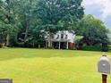 Traditional home exterior featuring a well-manicured lawn and a classic mailbox at 149 Crown Oaks Dr, Stockbridge, GA 30281