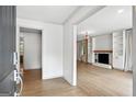 Open-concept living area with hardwood floors, fireplace, and stylish built-in shelving at 2676 Cottonwood Dr, Marietta, GA 30066