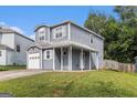 Inviting two-story home with a covered porch and well-maintained lawn in a suburban setting at 4706 Cedar Park Trl, Stone Mountain, GA 30083