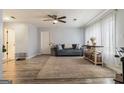Bright living room with wood-look floors, a large window, and stylish contemporary decor at 4706 Cedar Park Trl, Stone Mountain, GA 30083