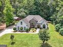Aerial view of a beautiful property, featuring a well-maintained lawn and verdant surrounding trees at 264 Line Creek Cir, Sharpsburg, GA 30277