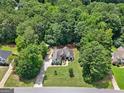An aerial view shows the home nestled in a forest at 264 Line Creek Cir, Sharpsburg, GA 30277