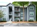 Exterior shot of a three-story apartment building with gray siding and white balconies at 5207 Santa Fe Pkwy, Sandy Springs, GA 30350