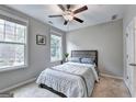 Bedroom filled with natural light, complemented by a ceiling fan at 711 Topsail Ln, Alpharetta, GA 30005