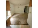 Open-concept dining room with chandelier, needs new flooring at 220 Peach Forest Pl, Douglasville, GA 30134