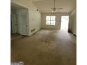 Spacious living room featuring high ceilings, large windows, a ceiling fan, and natural light throughout at 220 Peach Forest Pl, Douglasville, GA 30134