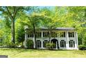Beautiful two-story home with a classic design, set amidst mature trees and a well-maintained yard at 909 Ne Otter Way Ne Way, Marietta, GA 30068