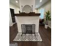 Stylish white brick fireplace with decorative tile and a wood mantel adding character to the living space at 2148 M L King Jr Sw Dr, Atlanta, GA 30310