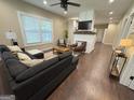 Spacious living room featuring wood floors, a cozy fireplace, and ample natural light from large windows at 2148 M L King Jr Sw Dr, Atlanta, GA 30310