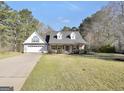 Charming home featuring a brick and siding facade, gabled roof, and manicured landscaping at 950 Besse Way, Locust Grove, GA 30248