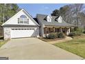 Charming home featuring a brick and siding facade, gabled roof, and manicured landscaping at 950 Besse Way, Locust Grove, GA 30248
