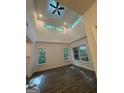 Bright, open living room with vaulted ceiling, modern ceiling fan, and sleek floors at 101 Dancing Fox Rd, Decatur, GA 30032