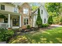 Close-up of a home's facade with stone accents, well-maintained landscaping, and a welcoming front porch at 1788 River Bluff Vw, Duluth, GA 30097