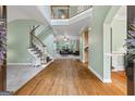Grand foyer with hardwood floors, a staircase, and views into the living room, creating an open and welcoming space at 1788 River Bluff Vw, Duluth, GA 30097