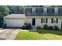 Charming home with a manicured lawn, two-car garage, and traditional curb appeal at 120 E Cainwood E Ct, Atlanta, GA 30349