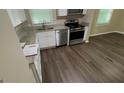 This kitchen features stainless steel appliances, modern cabinets and vinyl flooring at 120 E Cainwood E Ct, Atlanta, GA 30349