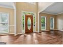 Bright foyer with soaring ceilings, wood floors, and a beautiful front door with glass panel at 3355 Golfe Links Dr, Snellville, GA 30039