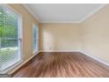 Spacious living room with ample natural light, neutral walls, and sleek wood flooring at 3355 Golfe Links Dr, Snellville, GA 30039