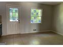 Dining room with tiled floors, white walls, and a glass-paned door and window at 6332 Valley Dale Dr, Riverdale, GA 30274