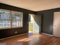 Sun-drenched living room featuring hardwood floors, gray walls, and a sunlit window at 6332 Valley Dale Dr, Riverdale, GA 30274