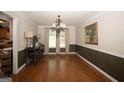 Dining room featuring hardwood floors, chandelier, picture frame, and natural light at 10038 Hemlock Way, Jonesboro, GA 30238