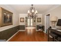Spacious dining room with hardwood floors, chandelier, picture frame, and natural light at 10038 Hemlock Way, Jonesboro, GA 30238