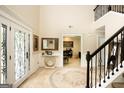 Spacious home foyer featuring tile floors, beautiful stairway and high ceilings, and modern decor at 10038 Hemlock Way, Jonesboro, GA 30238
