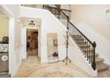 Elegant foyer with decorative rug, stairs, and doorway to kitchen, enhancing home's character at 10038 Hemlock Way, Jonesboro, GA 30238