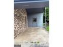 Spacious carport with gray trim that connects to a storage area in the back at 266 Ridge Trl, Riverdale, GA 30274