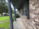 Covered porch with brick facade, providing a shaded entrance to the home at 266 Ridge Trl, Riverdale, GA 30274