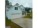 Charming two-story home with light blue siding, white trim, and a spacious driveway at 5341 Stewart Mill Rd, Douglasville, GA 30135