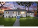 Charming single-story home with new exterior paint, dark roof and shutters, and a manicured lawn at 1092 Donnelly Sw Ave, Atlanta, GA 30310