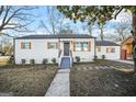 Charming single-story home with new exterior paint, dark roof and shutters, and a manicured lawn at 1092 Donnelly Sw Ave, Atlanta, GA 30310