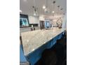 Spacious kitchen island with stone countertops and modern lighting at 2410 Thrasher Rd, Buford, GA 30519