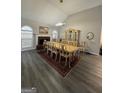 Elegant dining room featuring a fireplace, large dining table, and a vintage hutch at 25 Castlehill Ct, Covington, GA 30016